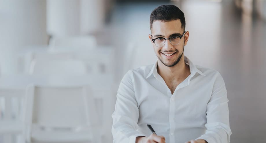 Man in suite with purple tie holding and iPad for onboarding